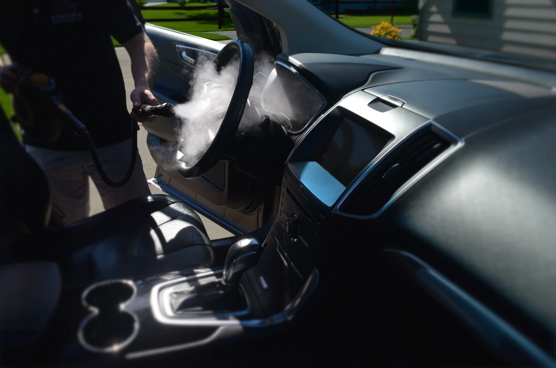 Fortify technician steam cleaning a vehicle interior